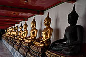 Bangkok Wat Pho, Buddha gilded statues lined in the double cloister enclosing the ubosot. 